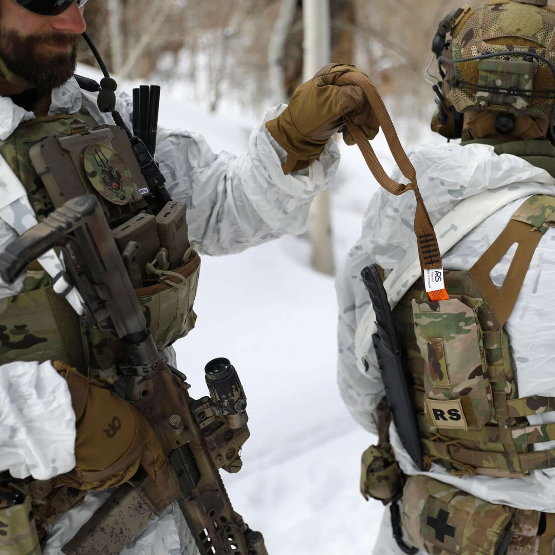Solider deploying Multi-Loop Rescue Strap in snowy terrain