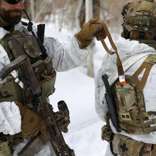 Solider deploying Multi-Loop Rescue Strap in snowy terrain