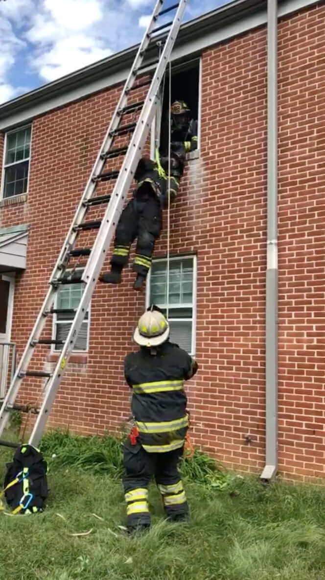 Firemen using Multi-Loop Rescue Strap in training exercise