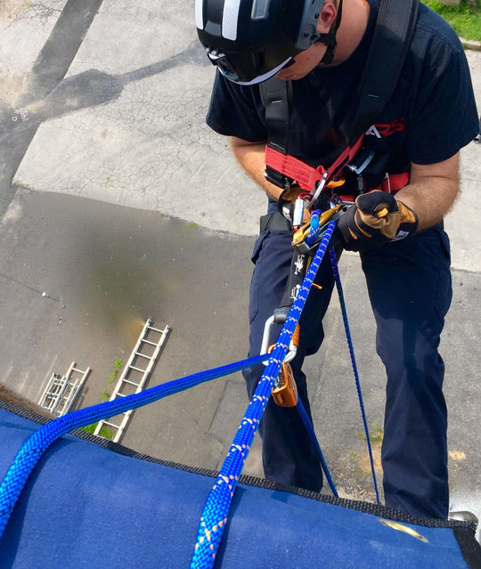 Man repelling with blue sterling rope